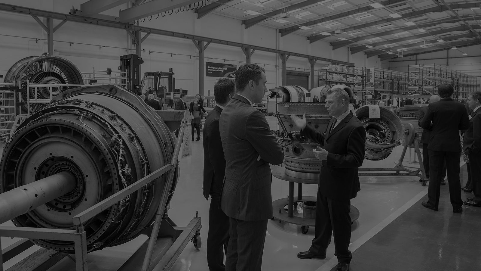 Men in suits looking at engines in the Aerfin HQ